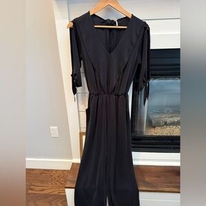 Free People Black silk like material jumpsuit  flowy cutout details size XS